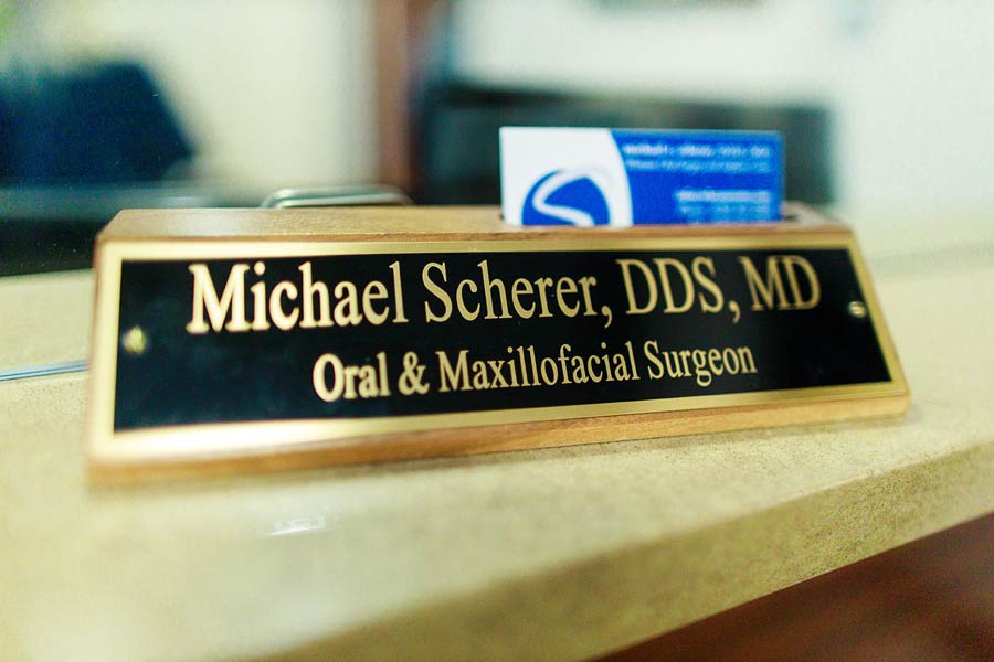 Dr. Scherer Oral & Maxillofacial Surgeon name plate on desk at Wheaton Oral Surgery in Naperville, IL