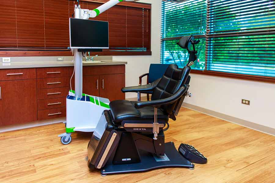 Dental exam room in exam chair at Wheaton Oral Surgery in Naperville, IL