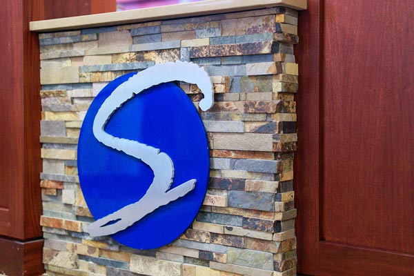 Logo on wall at Wheaton Oral Surgery in Naperville, IL