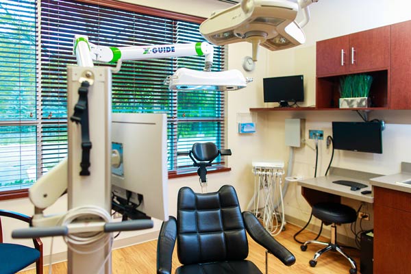 Dental exam chair in exam room at Wheaton Oral Surgery in Naperville, IL