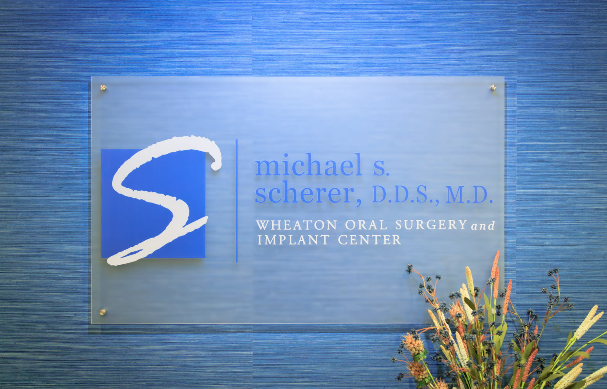 Dr. Scherer Oral & Maxillofacial Surgeon name plate on desk at Wheaton Oral Surgery in Naperville, IL