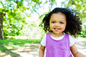 toddler in the park smiling